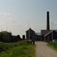 Zicht op stoomgemaal met schoorsteen vanaf entree van stoomgemaal Hertog Reijnout. © Gelders Archief (4190-6348), PD.
