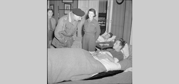 VeldmaarschalkMontgomery praat met Guardsman C B Rhodes, een Canadese militair die gewond was geraakt tijdens operatie 'Veritable', maart 1945.