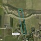 Vanuit de lucht zie je aan weerszijden van de dijk de nog bestaande delen (groen) van de oorspronkelijke crevasse (blauw) © Gemeente Beuningen	- CC-BY